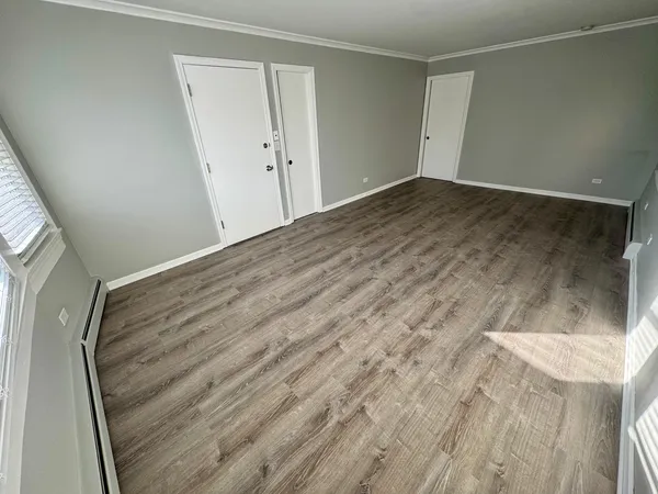 a view of hallway with wooden floor