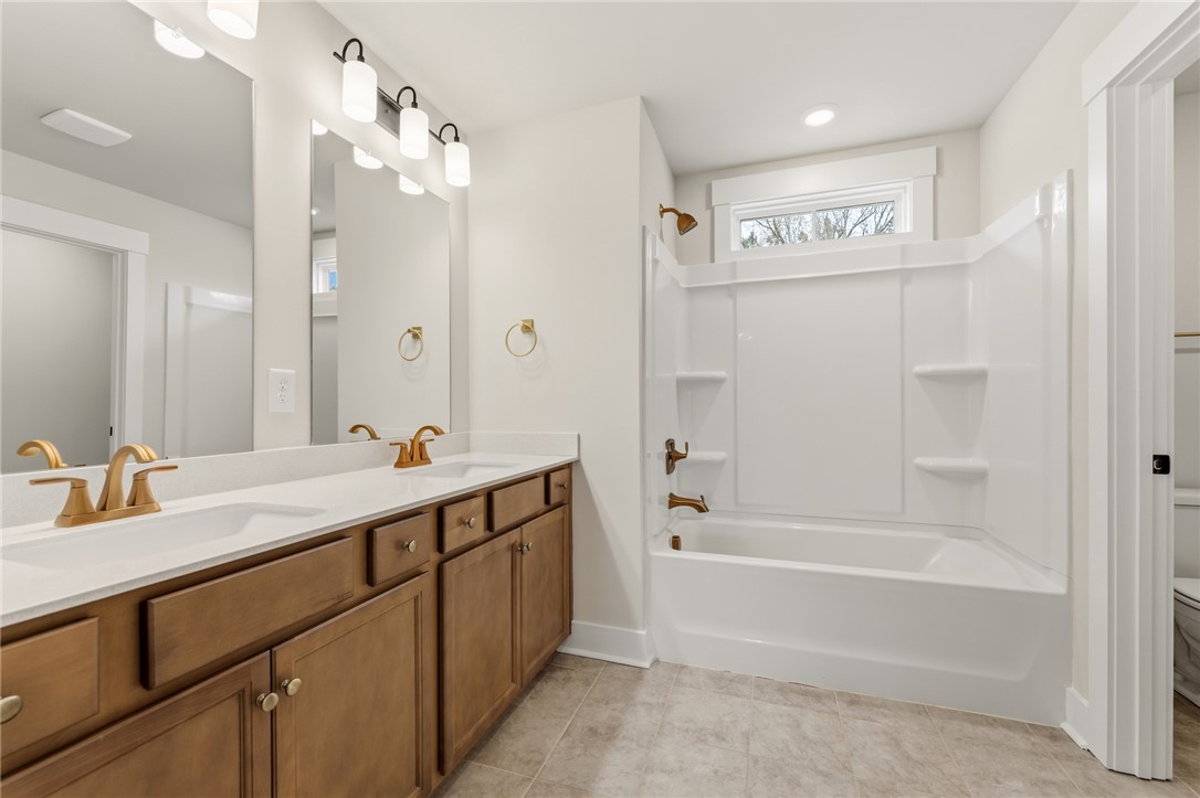 319 Summerall Drive Anderson, SC 29621 - Photo 28 of 37 This bathroom features a double vanity and a bathtub, offering comfort and convenience.