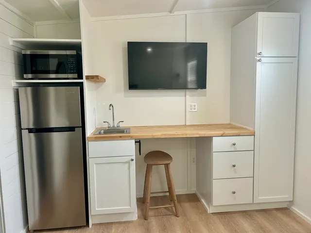 a kitchen with a refrigerator and a sink