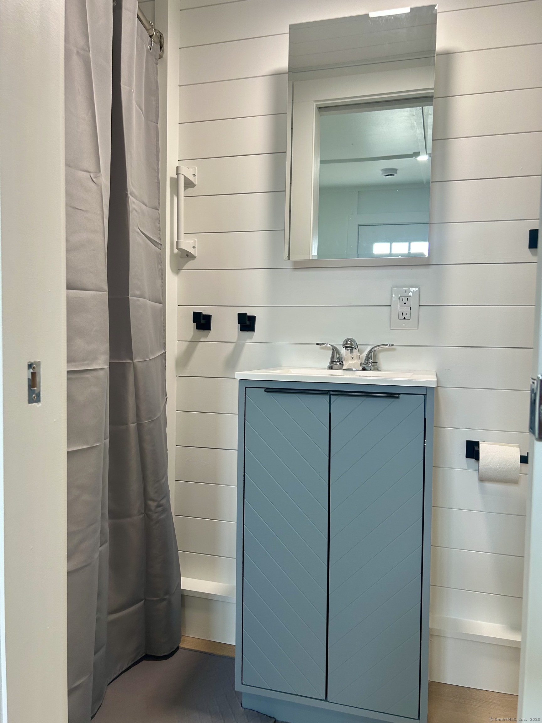 901 Stonington Road Stonington, CT 06379 - Photo 5 of 6 a bathroom with a sink and a mirror