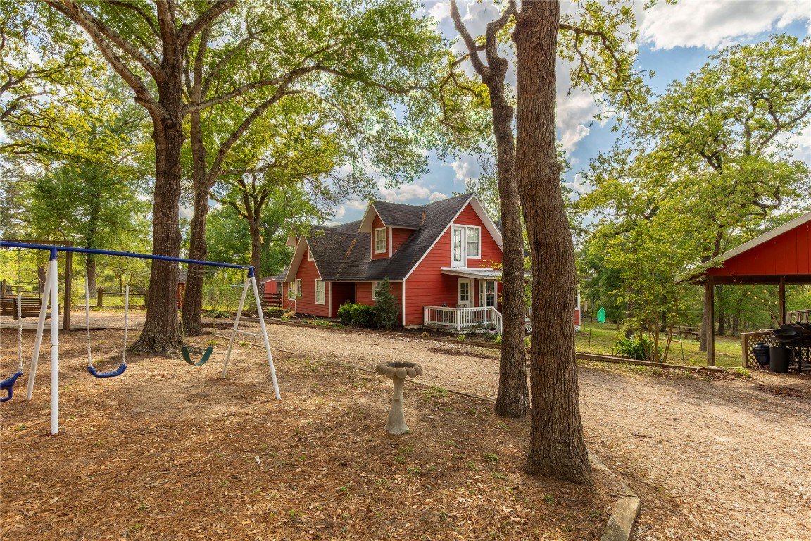 636 Deer Run Road Bellville, TX 77418 - Photo 3 of 23 a view of a tree in front of a house