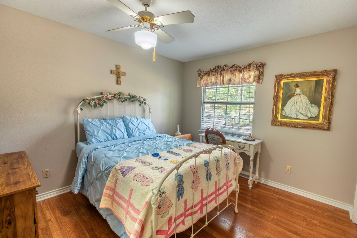 636 Deer Run Road Bellville, TX 77418 - Photo 10 of 23 a bedroom with a bed and wooden floor
