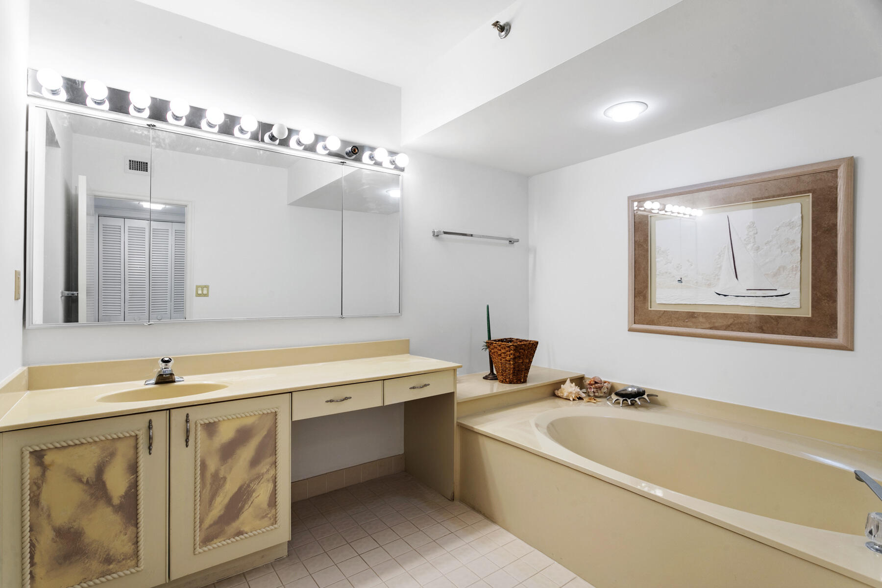 3322 Casseekey Island Road, Unit 504 Jupiter, FL 33477 - Photo 24 of 46 a bathroom with a tub a sink and mirror