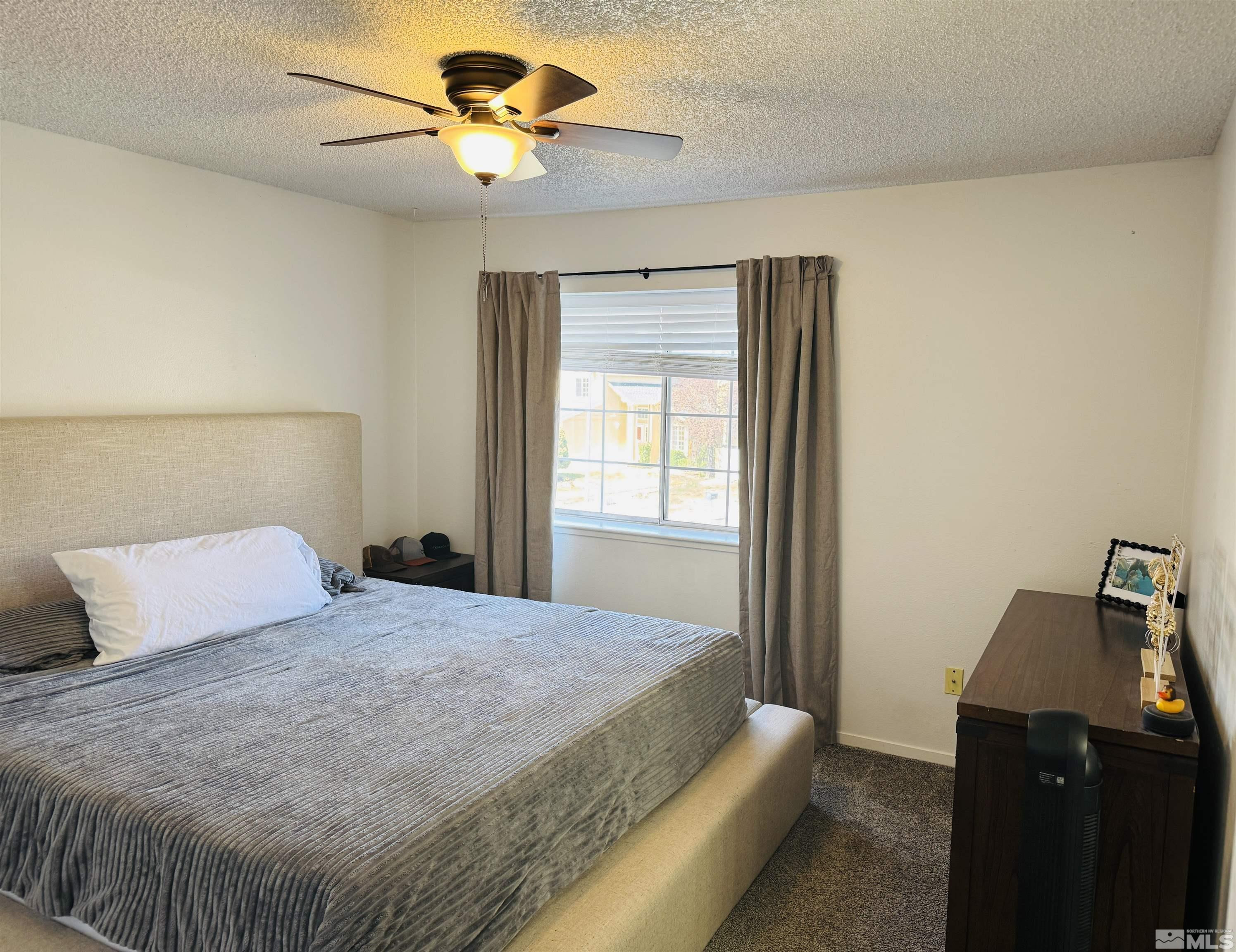 4360 Perro Lane Reno, NV 89502 - Photo 9 of 27 a bedroom with a bed and a window