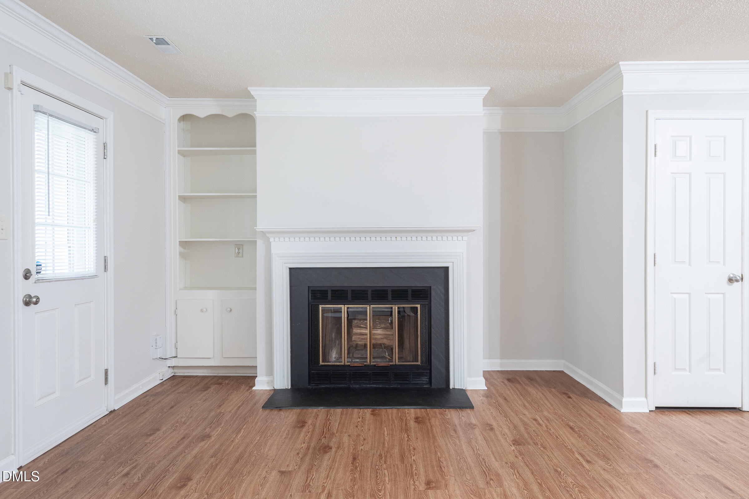 4418 Roller Court Raleigh, NC 27604 - Photo 11 of 16 a living room with a fireplace and wooden floor