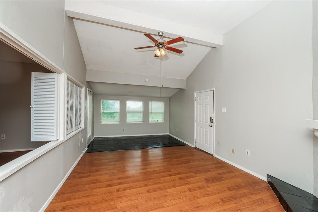 9696 Walnut Street, Unit 1216 Dallas, TX 75243 - Photo 9 of 19 Spacious room featuring vaulted ceilings, wood-finish flooring, a ceiling fan, and multiple windows