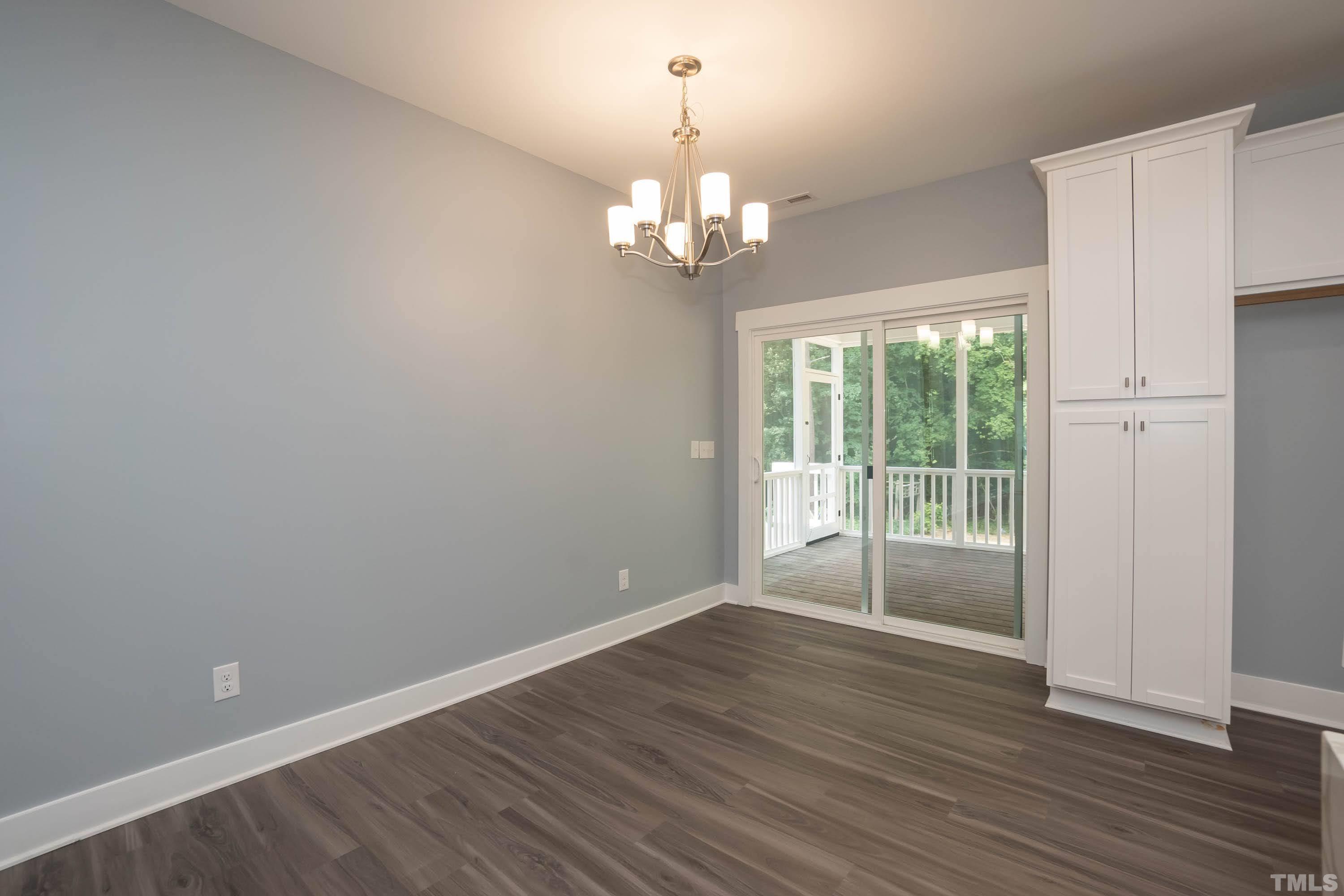 1701 Honeysuckle Road Raleigh, NC 27609 - Photo 13 of 29 a view of an empty room with wooden floor and a window