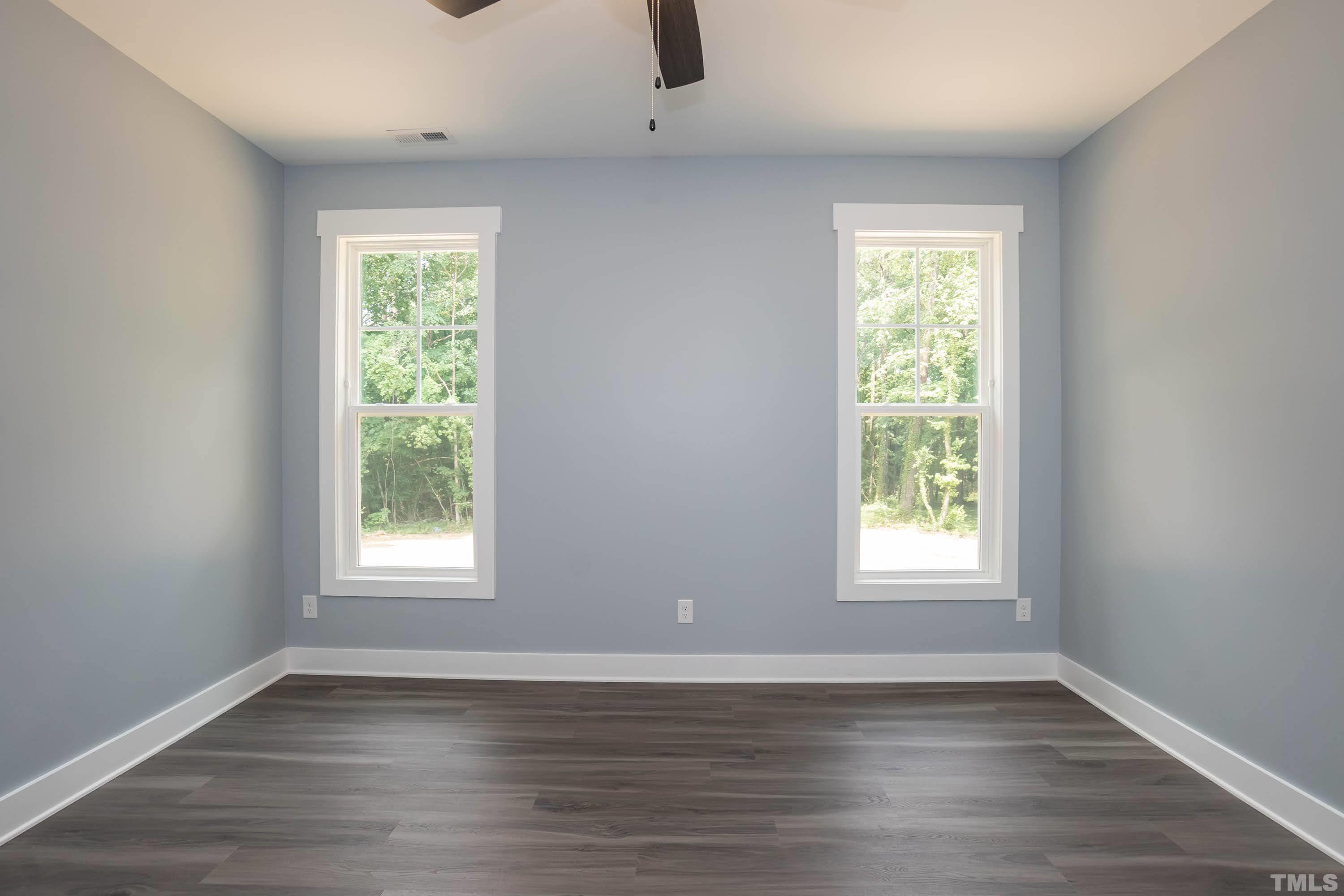 1701 Honeysuckle Road Raleigh, NC 27609 - Photo 15 of 29 an empty room with wooden floor and windows
