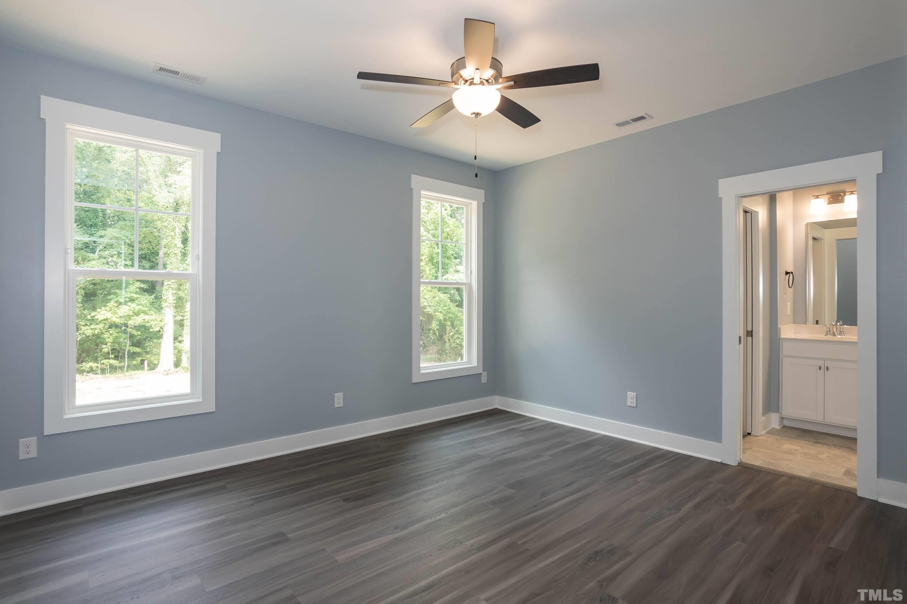 1701 Honeysuckle Road Raleigh, NC 27609 - Photo 16 of 29 a view of an empty room with wooden floor and a window