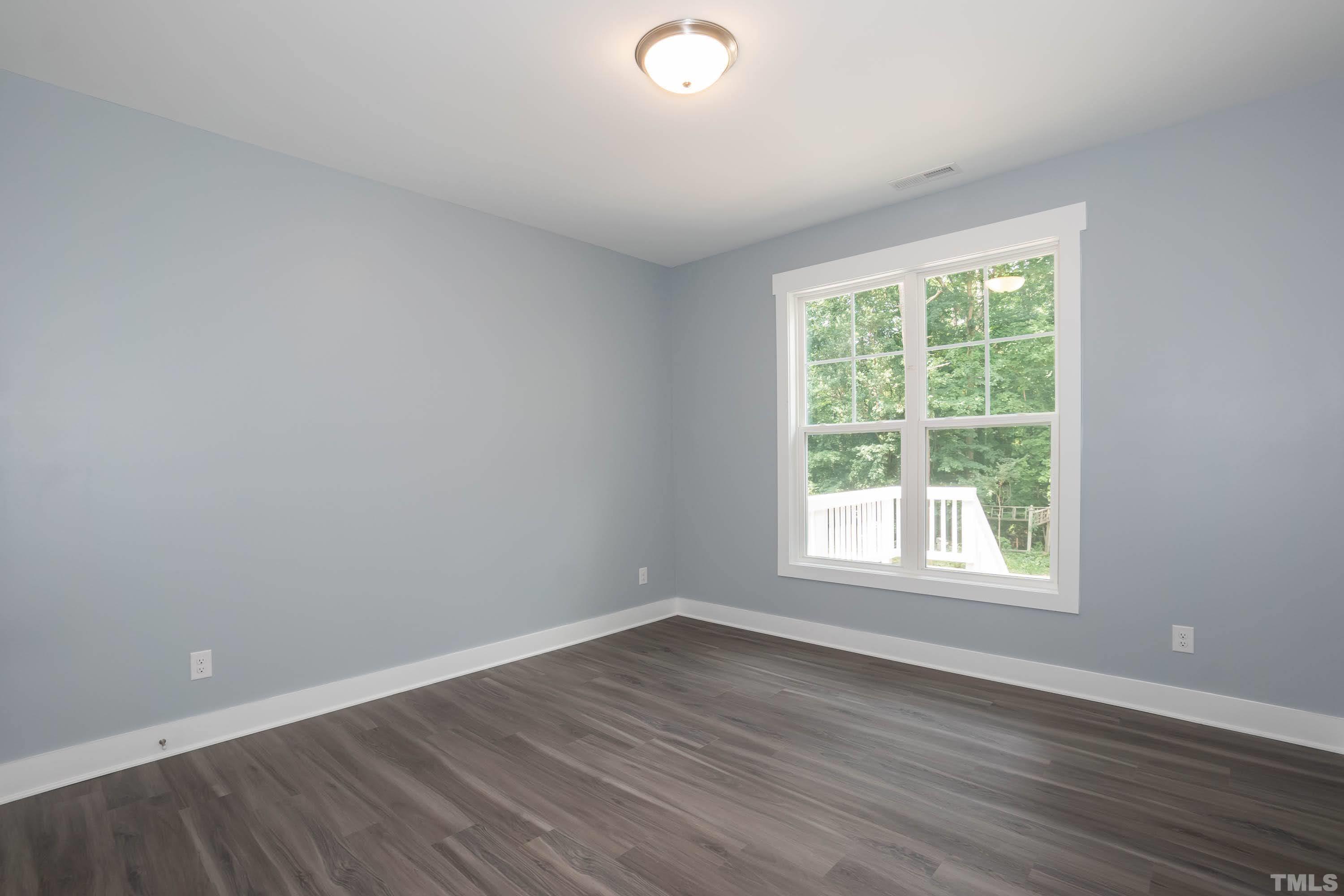 1701 Honeysuckle Road Raleigh, NC 27609 - Photo 20 of 29 an empty room with wooden floor and windows