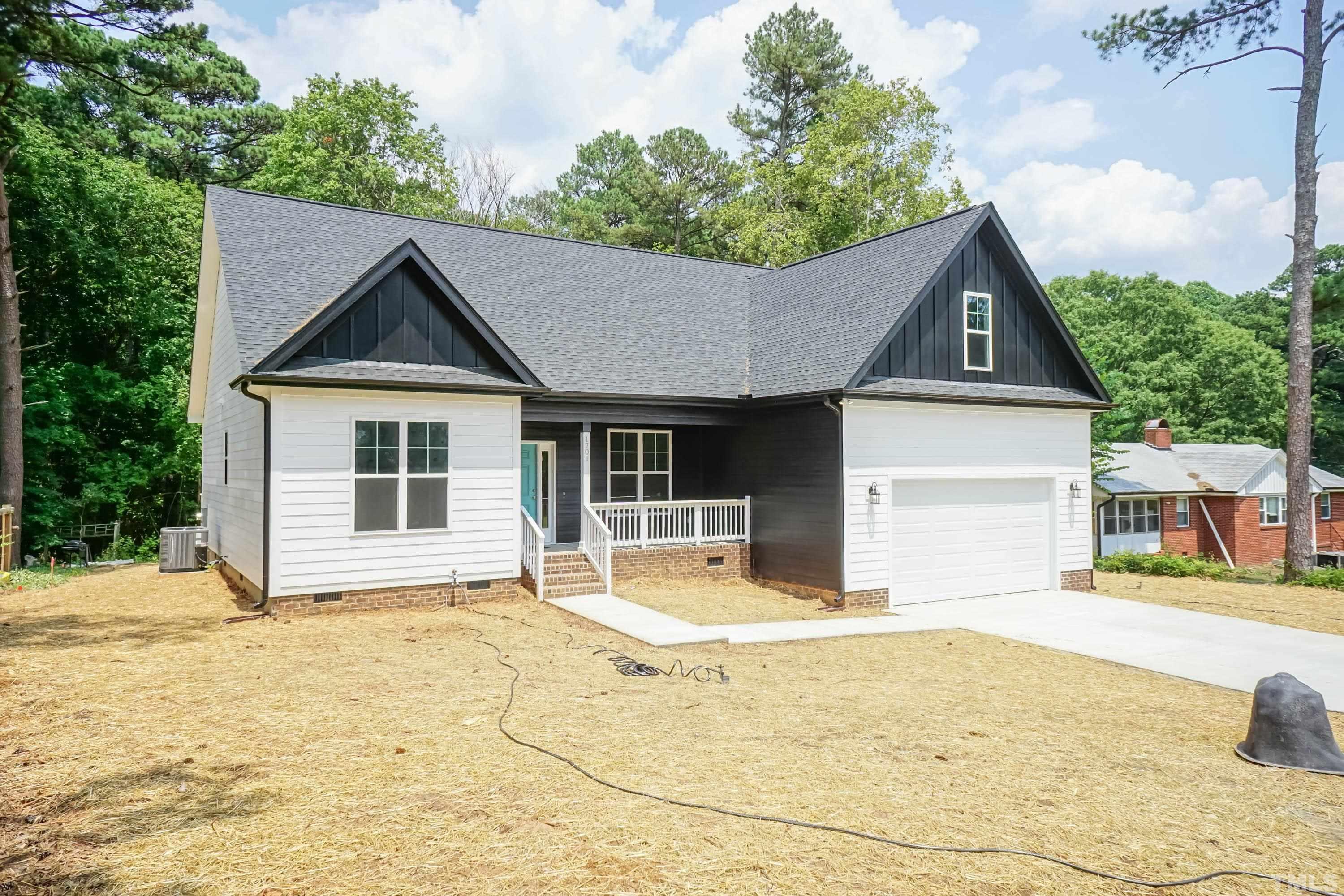 1701 Honeysuckle Road Raleigh, NC 27609 - Photo 2 of 29 a house with trees in the background