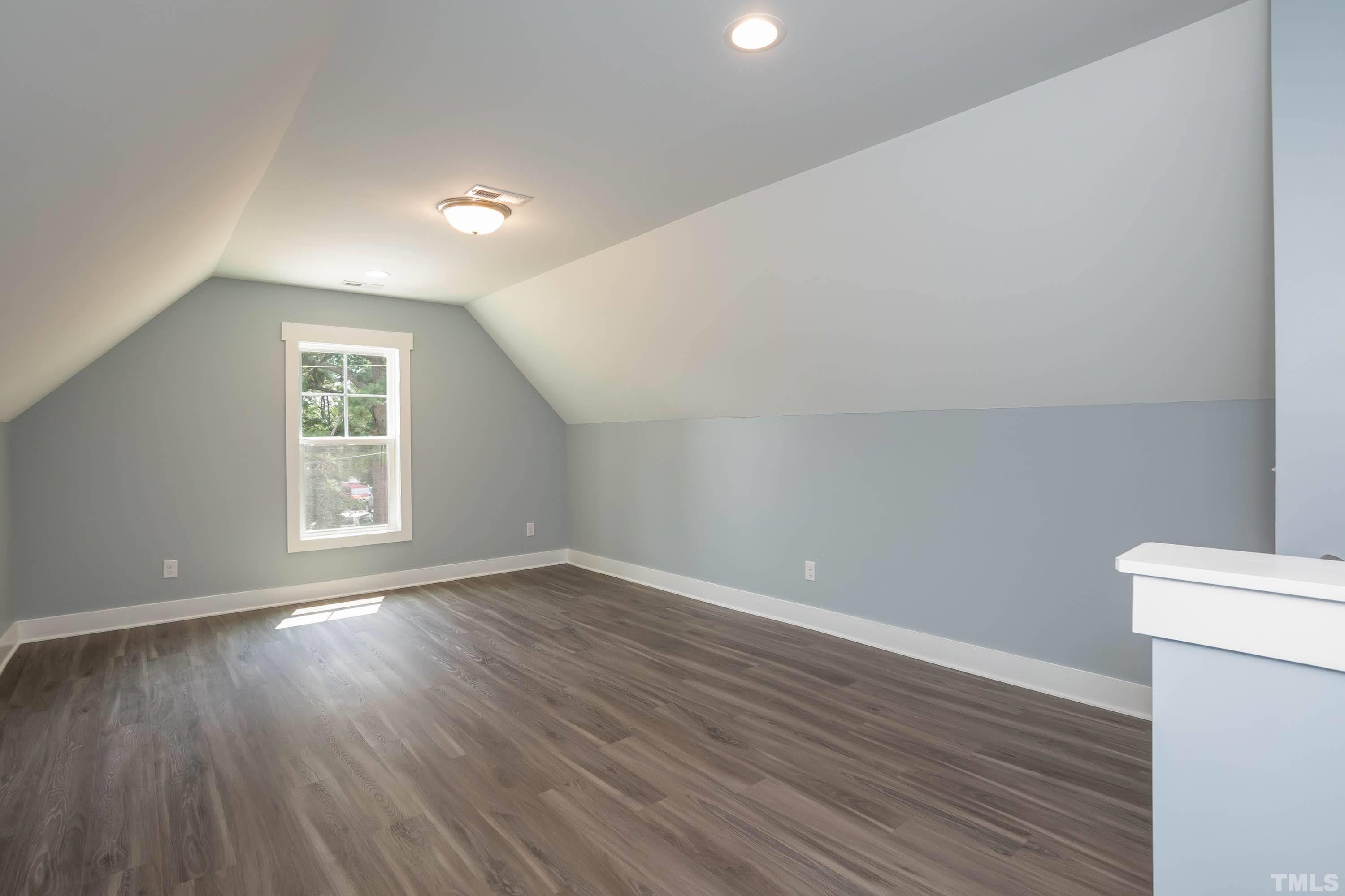 1701 Honeysuckle Road Raleigh, NC 27609 - Photo 22 of 29 a view of an empty room with wooden floor and a window