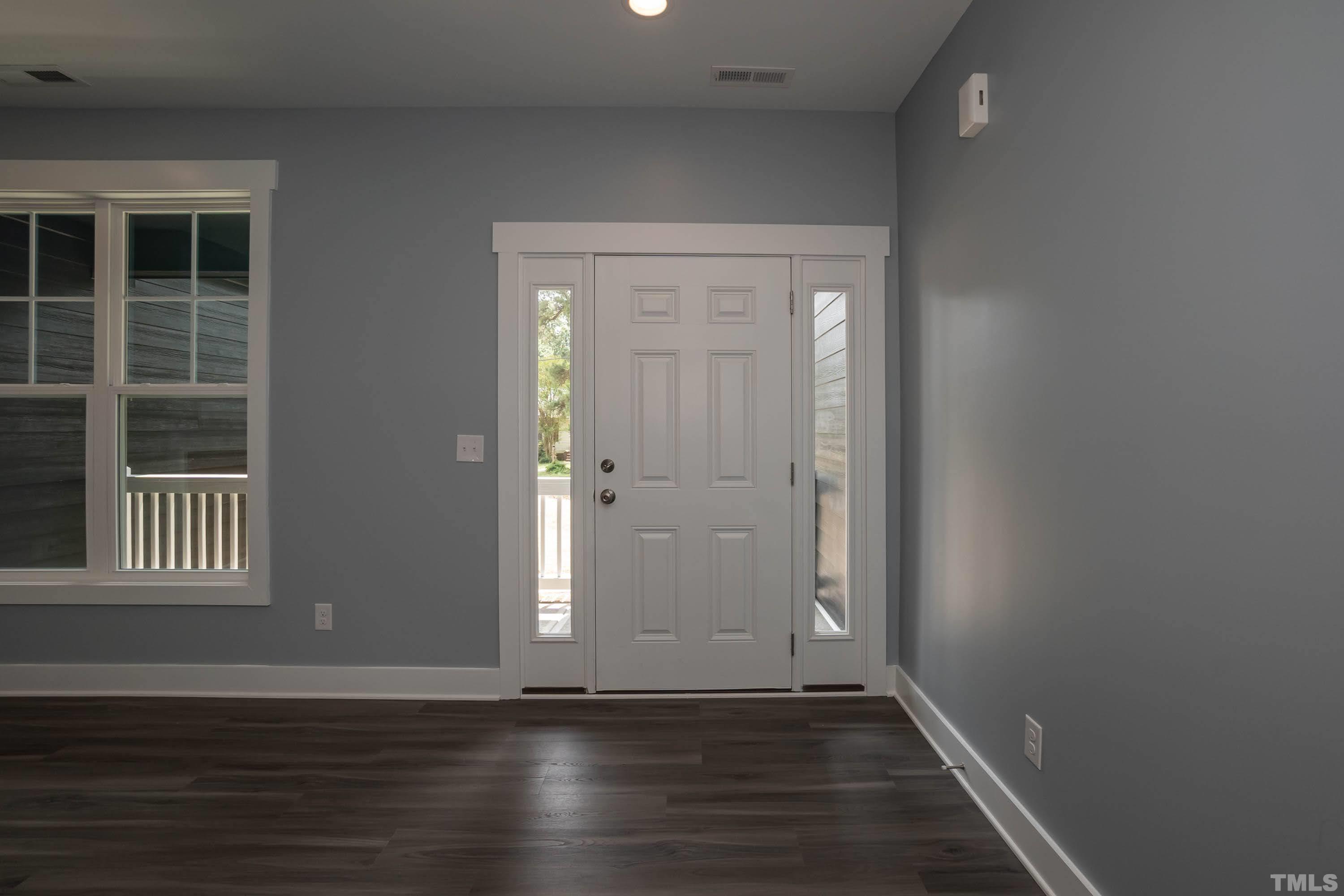 1701 Honeysuckle Road Raleigh, NC 27609 - Photo 4 of 29 an empty room with wooden floor and windows