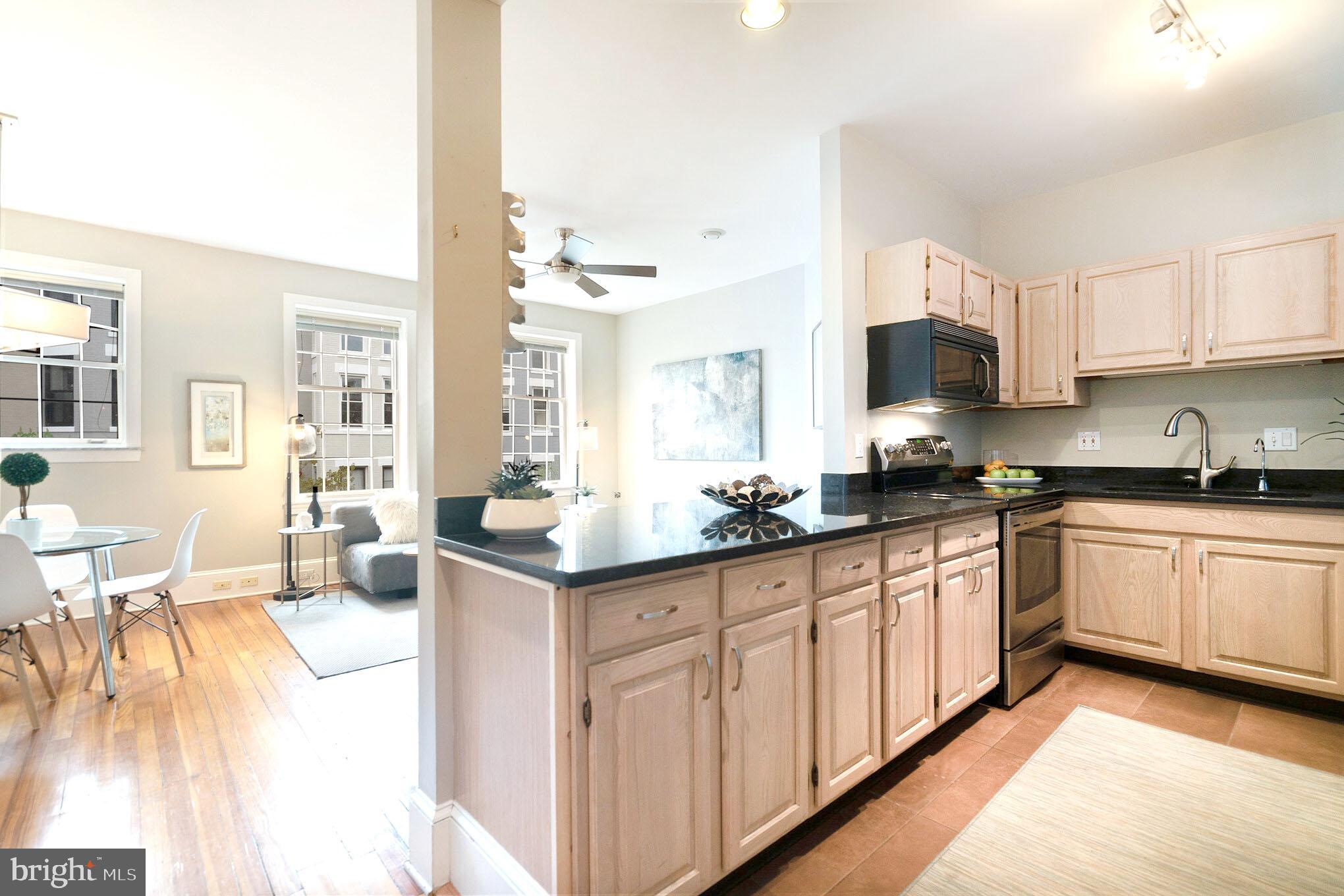 1754 Willard Street Northwest, Unit 2 Washington, DC 20009 - Photo 5 of 28 a kitchen with granite countertop a sink and cabinets