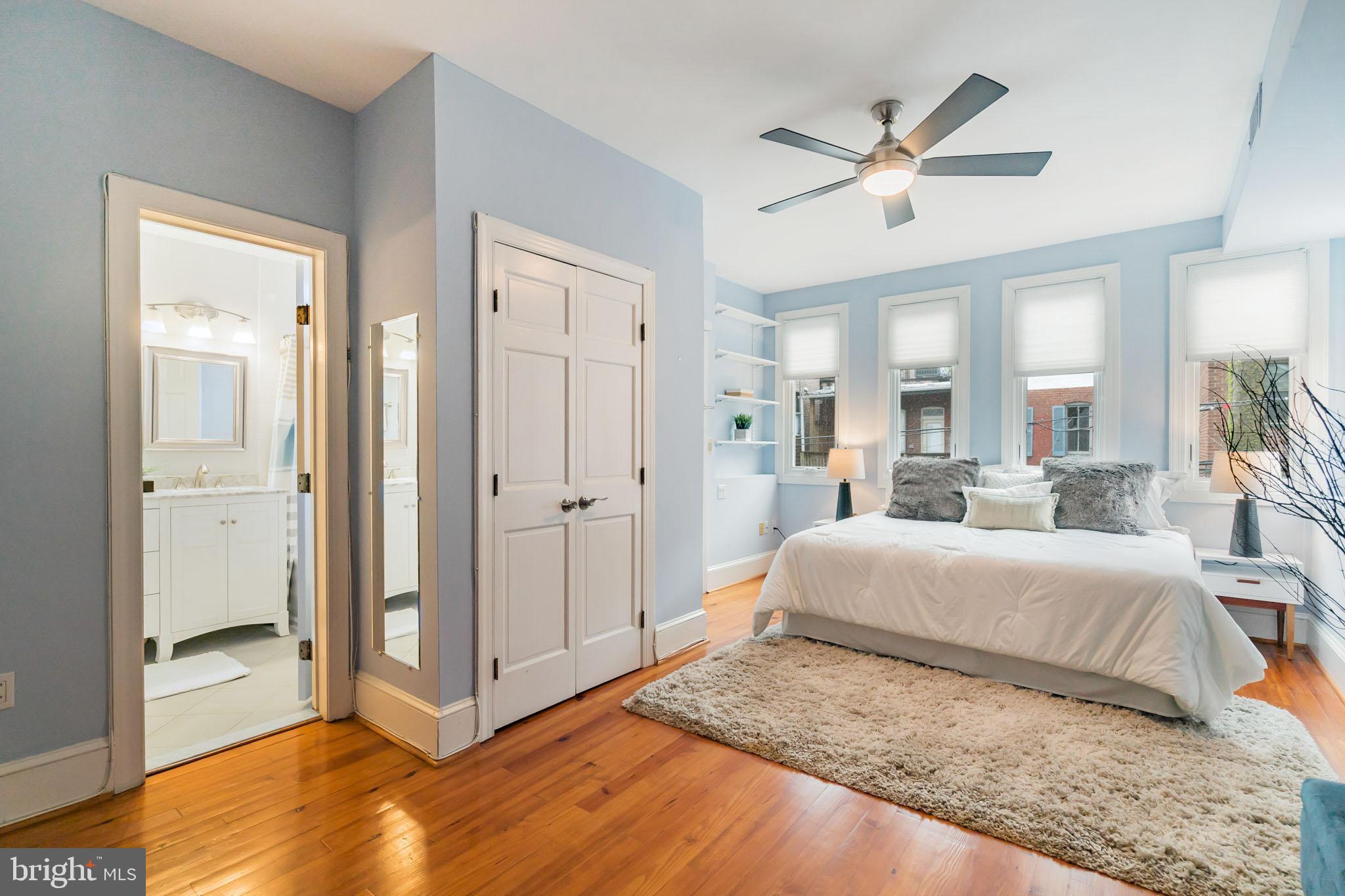 1754 Willard Street Northwest, Unit 2 Washington, DC 20009 - Photo 9 of 28 a bedroom with a large bed and a chandelier