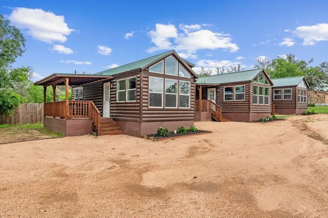 a front view of a house with a yard covered in snow