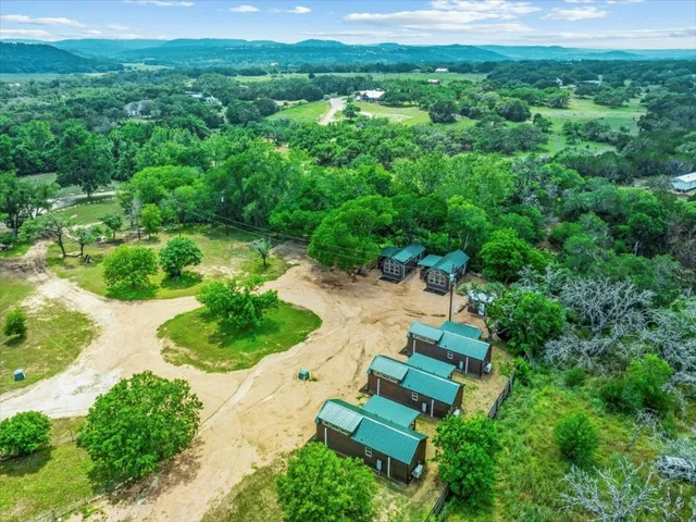 a view of a backyard with couches and swimming pool