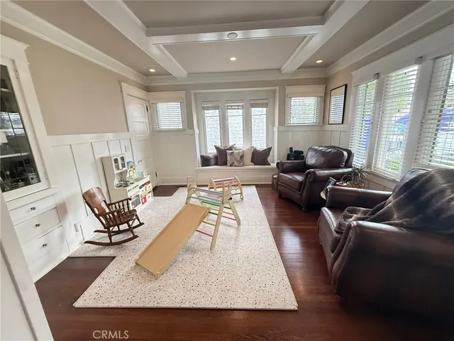 a living room with furniture rug and large windows