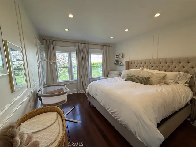 a bedroom with a bed and windows