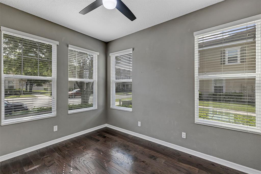 7644 Ripplepointe Way Windermere, FL 34786 - Photo 20 of 52 a view of an empty room with a window and wooden floor