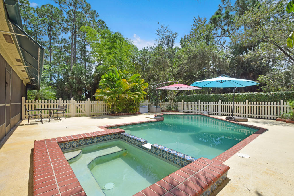 15429 Jupiter Farms Road Jupiter, FL 33478 - Photo 19 of 59 a view of a swimming pool with a garden