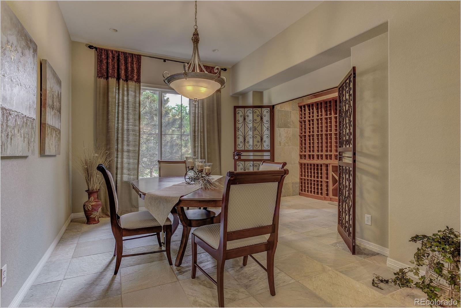 9061 Hunters Way Highlands Ranch, CO 80129 - Photo 15 of 33 a dining room with furniture a chandelier and window