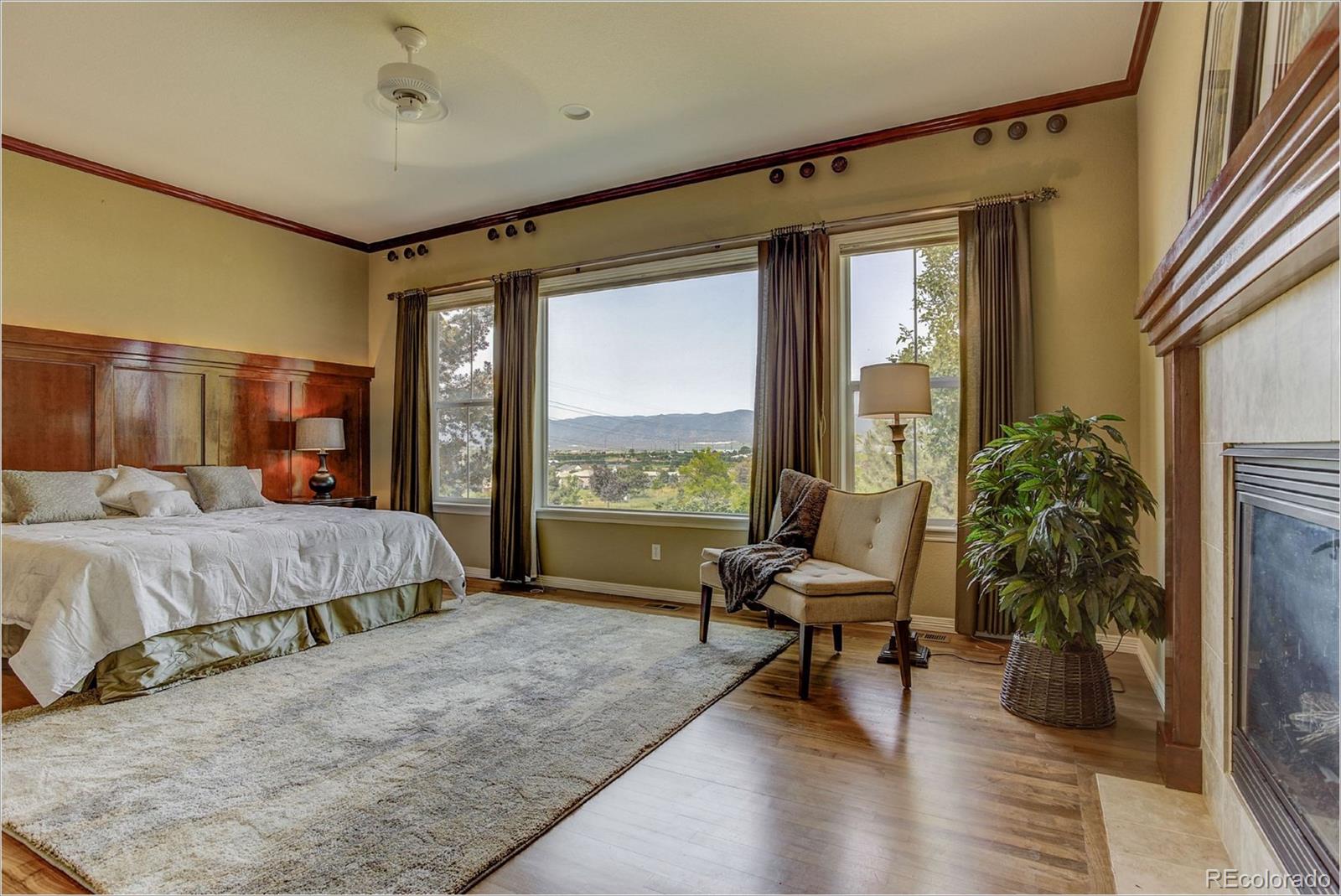 9061 Hunters Way Highlands Ranch, CO 80129 - Photo 20 of 33 a bed room with a bed and a chair