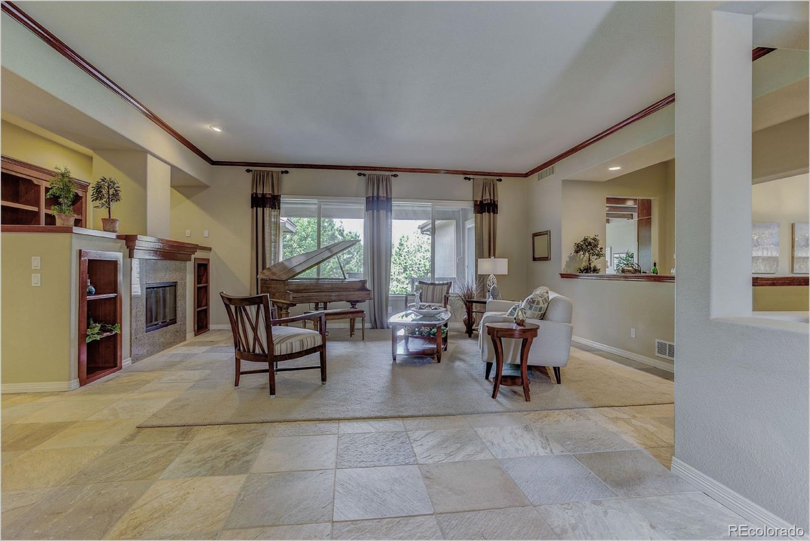 9061 Hunters Way Highlands Ranch, CO 80129 - Photo 2 of 33 a living room with furniture and large windows