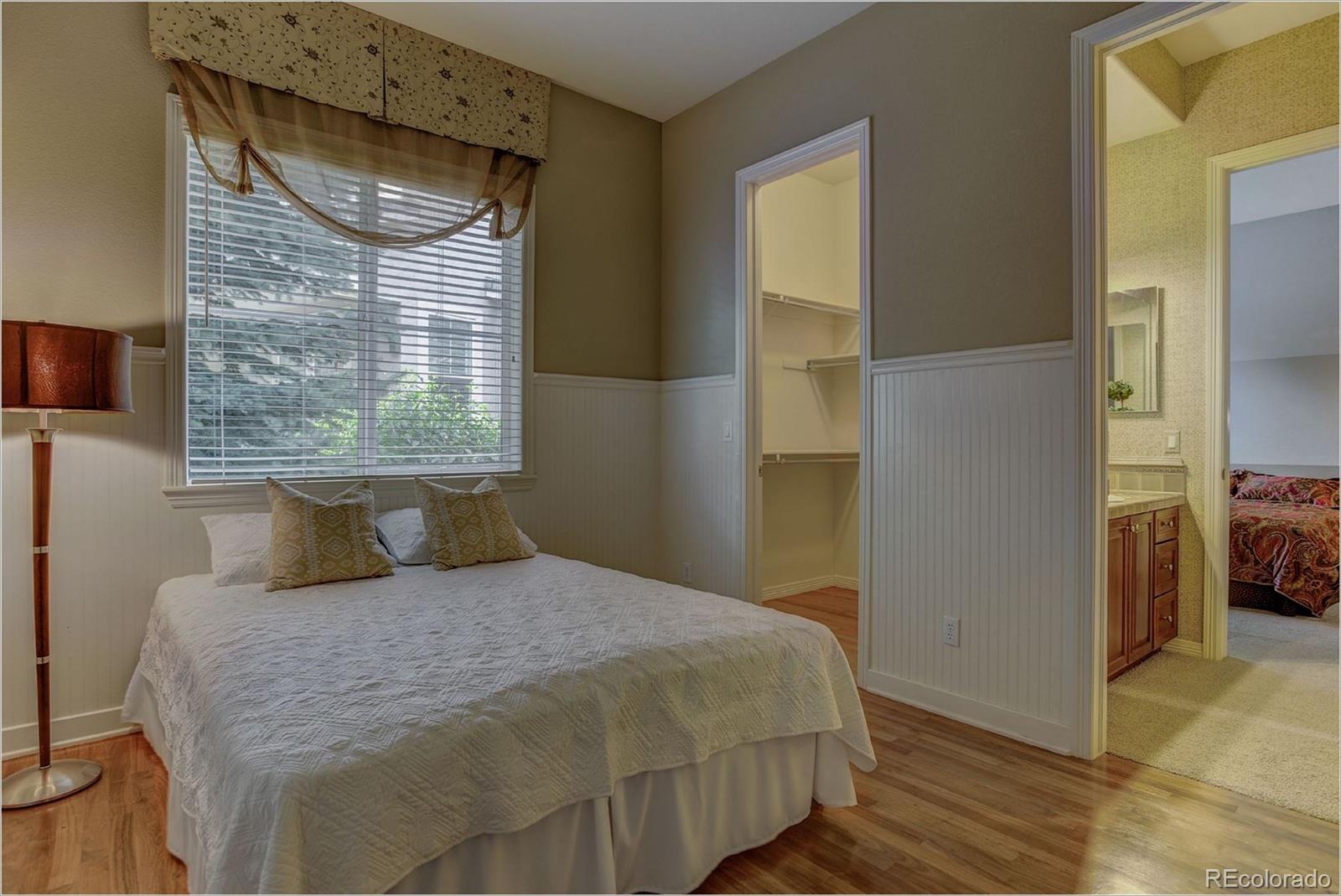 9061 Hunters Way Highlands Ranch, CO 80129 - Photo 23 of 33 a bedroom with a bed and a window