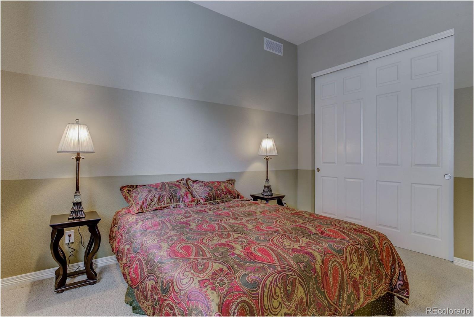 9061 Hunters Way Highlands Ranch, CO 80129 - Photo 24 of 33 a bedroom with a bed and a lamp