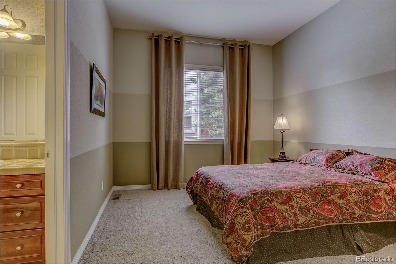 9061 Hunters Way Highlands Ranch, CO 80129 - Photo 25 of 33 a bedroom with a bed and a window