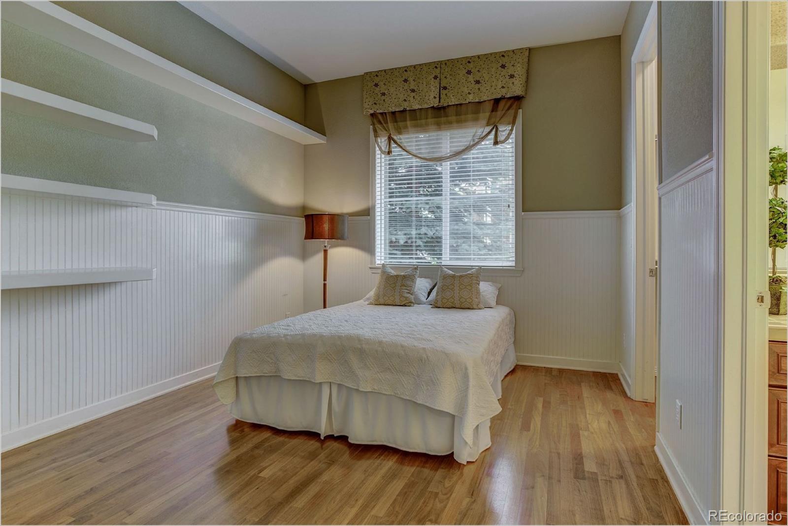 9061 Hunters Way Highlands Ranch, CO 80129 - Photo 26 of 33 a bedroom with a bed and a window