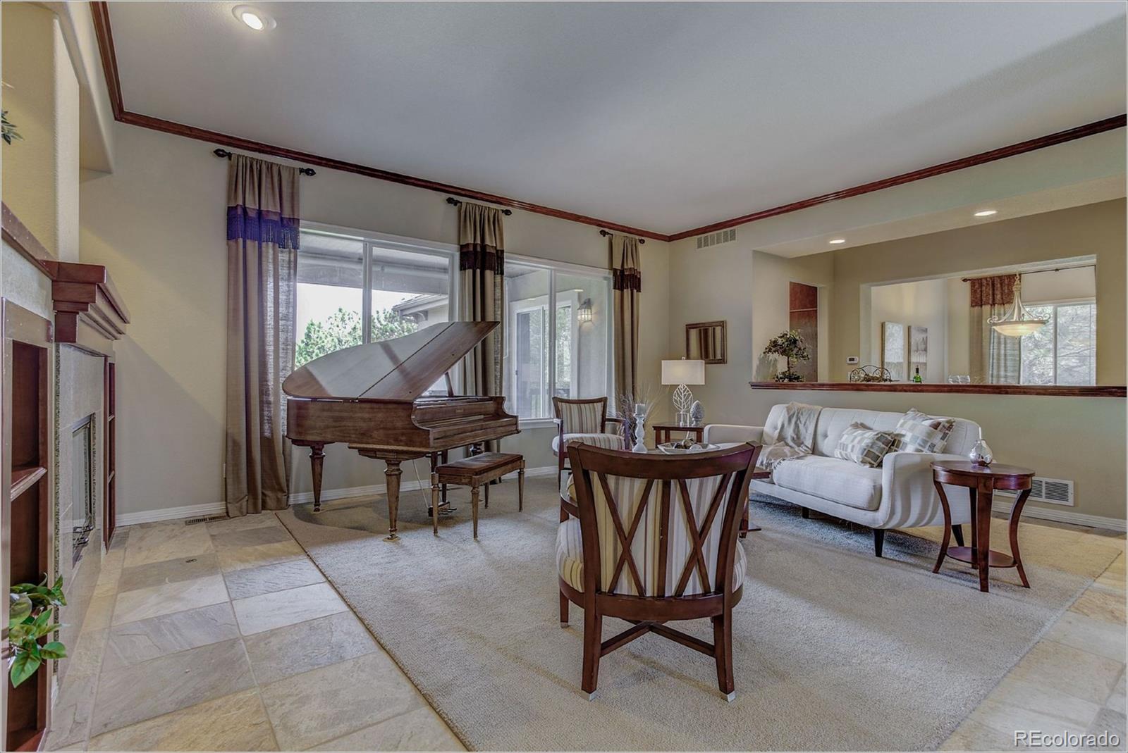 9061 Hunters Way Highlands Ranch, CO 80129 - Photo 3 of 33 a dining room with furniture and a floor to ceiling window