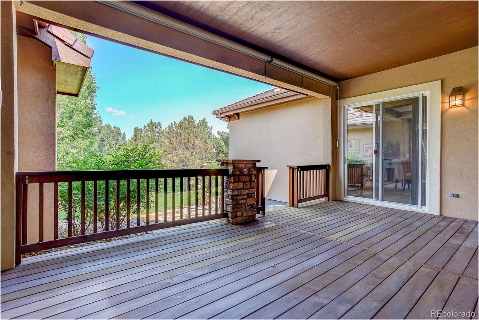 9061 Hunters Way Highlands Ranch, CO 80129 - Photo 31 of 33 a view of a porch with wooden floor