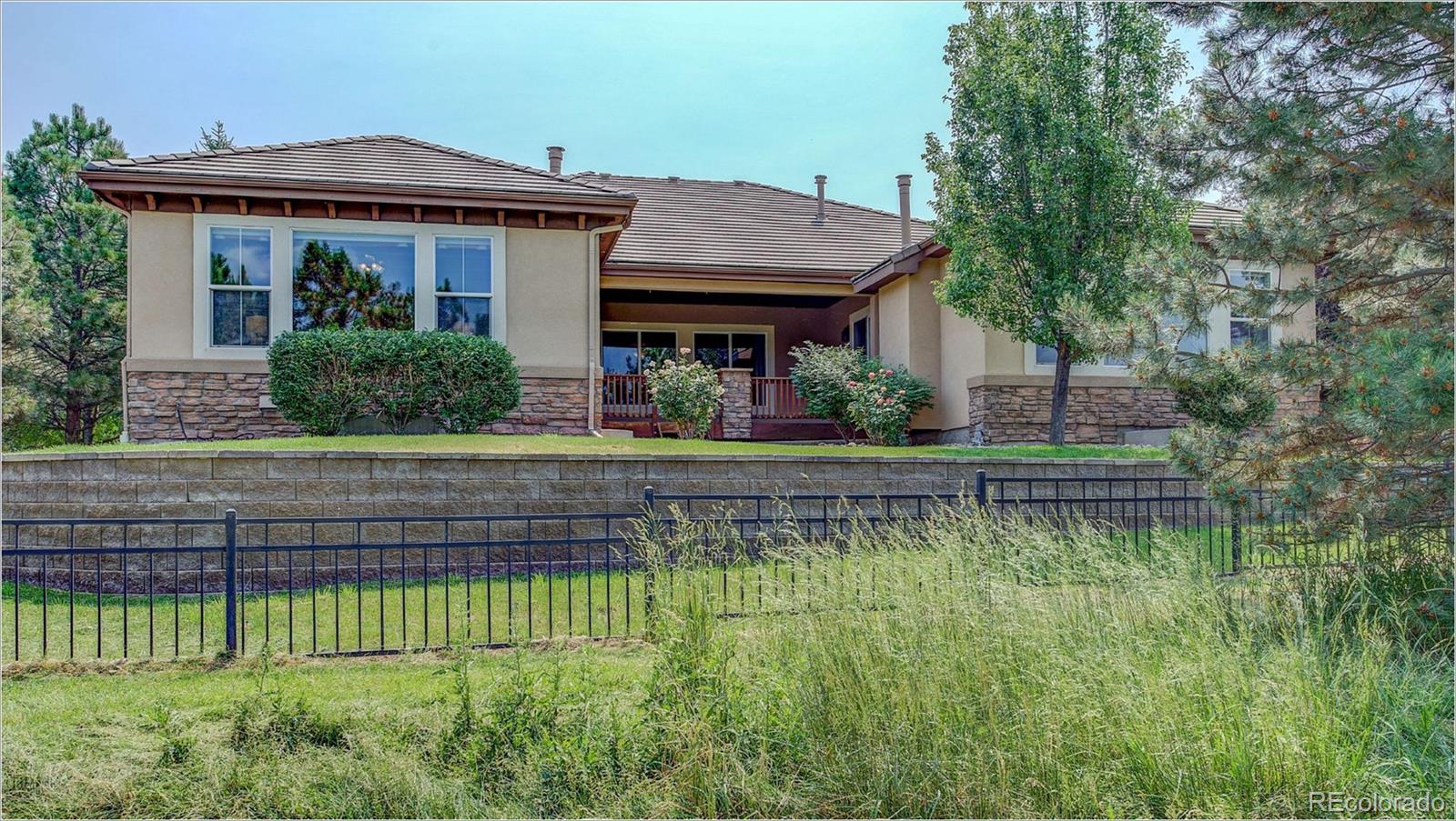 9061 Hunters Way Highlands Ranch, CO 80129 - Photo 32 of 33 a front view of a house with a yard