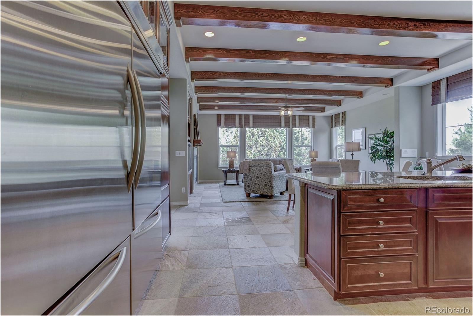 9061 Hunters Way Highlands Ranch, CO 80129 - Photo 5 of 33 a room with lots of wooden furniture and a porch