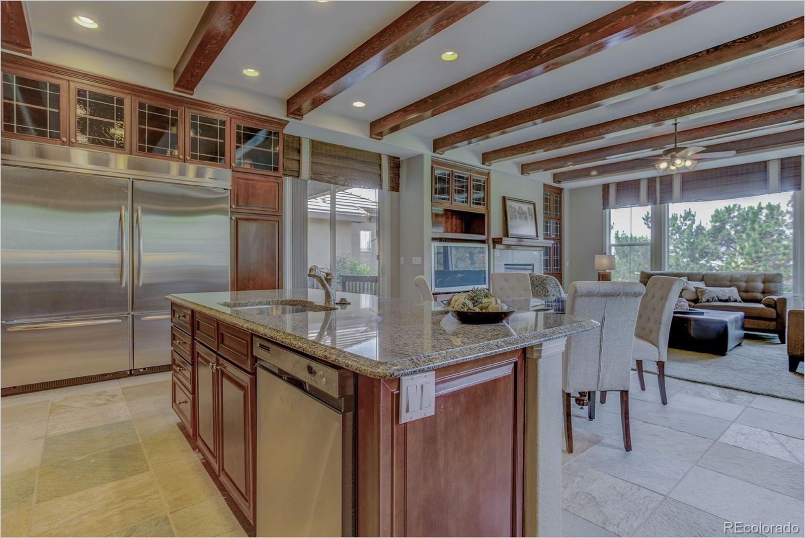 9061 Hunters Way Highlands Ranch, CO 80129 - Photo 9 of 33 a kitchen with stainless steel appliances granite countertop a sink and a refrigerator