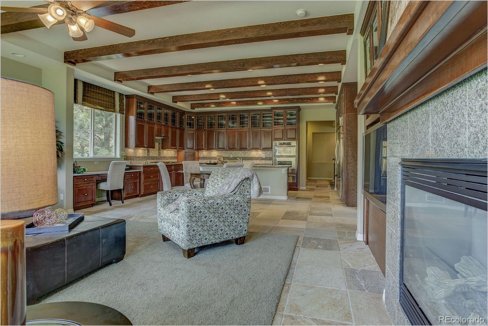 9061 Hunters Way Highlands Ranch, CO 80129 - Photo 10 of 33 a living room with furniture and a fireplace