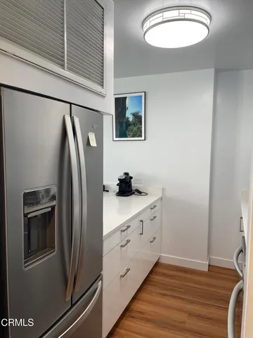 a kitchen with stainless steel appliances granite countertop a refrigerator and a sink
