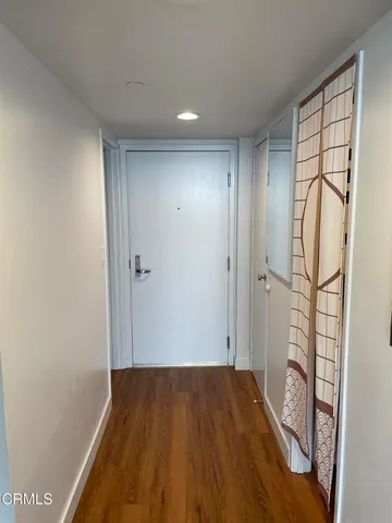 a view of hallway with wooden floor