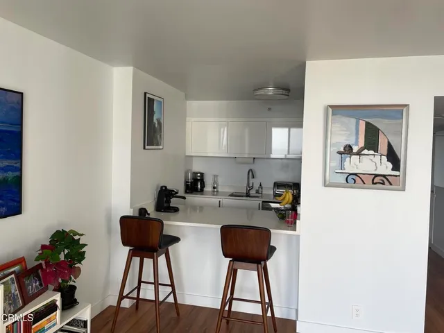 a kitchen with a refrigerator and cabinets