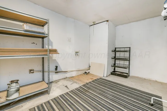 an empty room with a fan & a ceiling fan