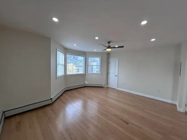 a view of an empty room and a window
