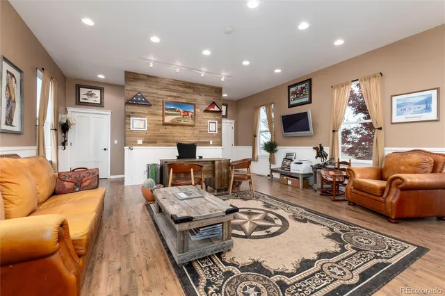 an aerial view of ocean and residential houses with outdoor space