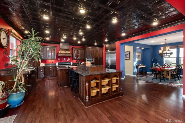 a living room with lots of furniture and kitchen view