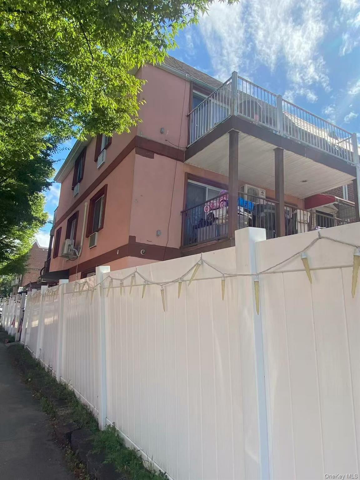 a view of a house with a wooden fence