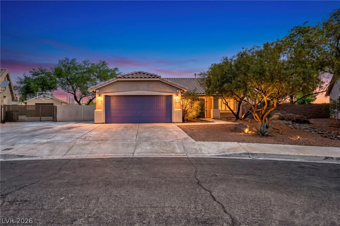 1234 Sunfire Street Henderson, NV 89014 - Photo 1 of 40 A well-lit desert landscape frames the inviting entrance of this charming residence.