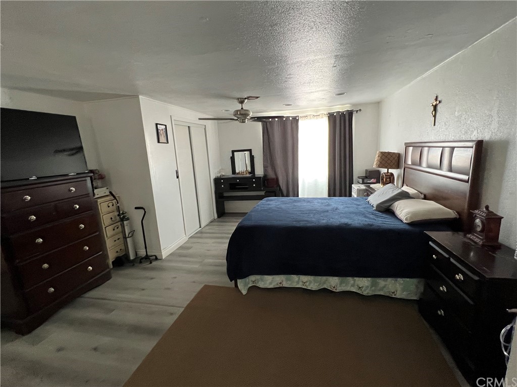 39311 Howard Road Anza, CA 92539 - Photo 11 of 23 a bedroom with a bed and wooden floor