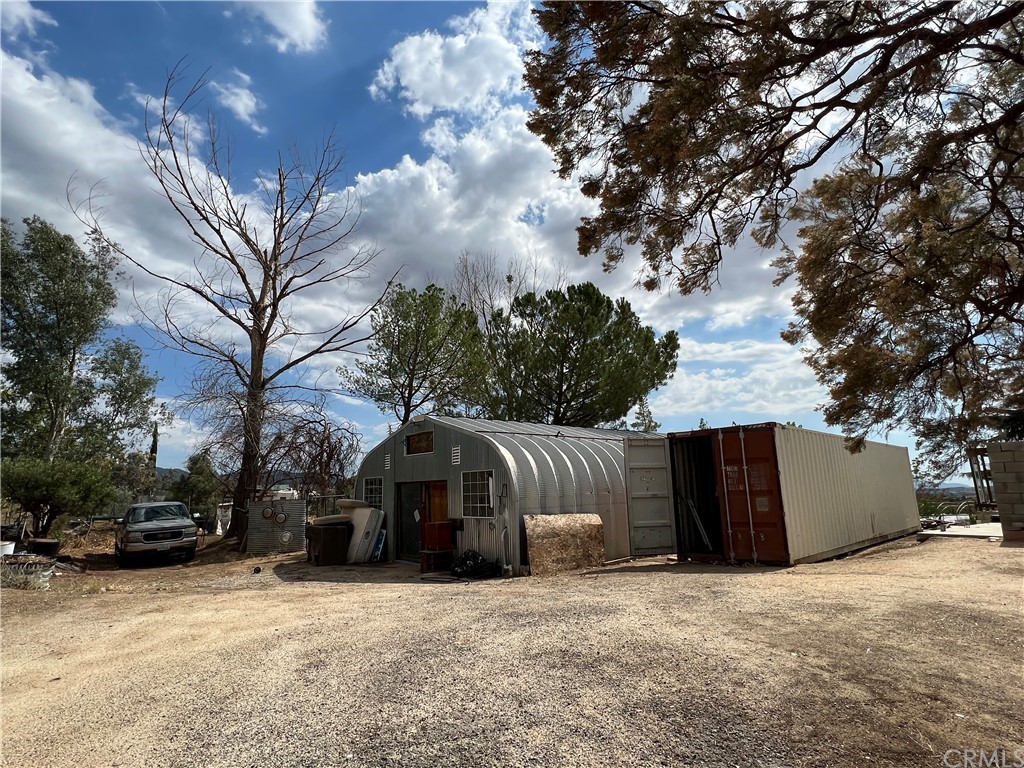 39311 Howard Road Anza, CA 92539 - Photo 22 of 23 a front view of a house with a yard and garage