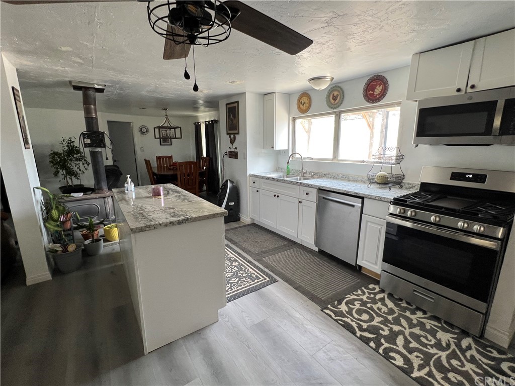 39311 Howard Road Anza, CA 92539 - Photo 3 of 23 a kitchen with sink cabinets and window